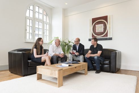 Sales people discussing at Wirkung Plus lounge in Hamburg